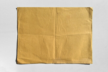 Brown and beige cardboard paper mail envelope on a white background