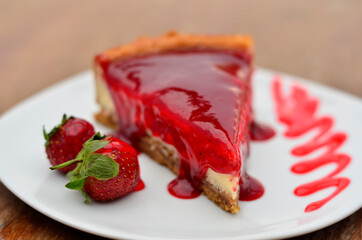 cheese cake with strawberries on table
