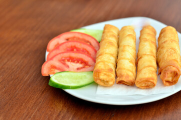 turkish cigar burek with tomatoes and cucumber