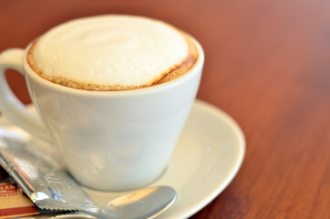 cappucino in white cup on wood table