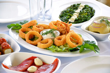 Fried calamary with greens and mezes