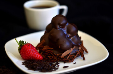chocolate cake with strawberry and cup of coffee