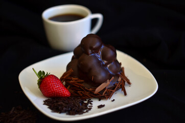chocolate cake with strawberry and cup of coffee