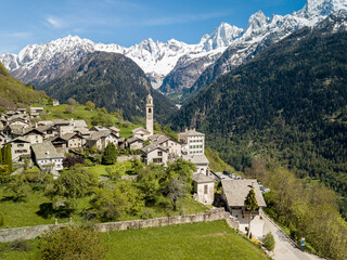 Fototapeta na wymiar Aerial image of the Swiss mountain village Solio with the snow-capped Sciora range at the background. Soglio was creadited as one the most beautiful village in Switzerland.
