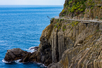 The narrow walkway for hiking on a cliff overlooking the Mediterranean  sea in Ciiqua Terra Italy
