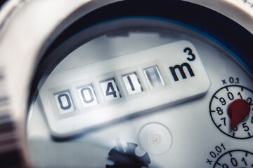 Close up of water meter with rotating digit. - obrazy, fototapety, plakaty