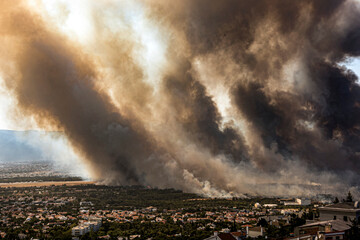 Athens, Greece, 03 August 2021: View of a major wild fire reached residential areas, at Varympompi...