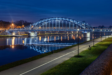 Pilsudski steel truss bridge over Vistula river in Krakow in the night