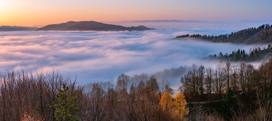 Misty autumn mountains landscape in the morning, Poland, Beskidy mountains and Tatra mountains in the background