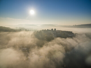 Aerial view of Tyniec abbey in the morning mists, beautiful sunrise, Krakow, Poland