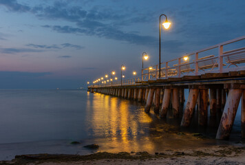 Baltic sea coast, night view of pier at Gdynia Orlowa sea resort, Poland.
