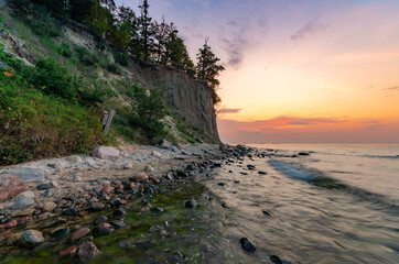 Fototapeta na wymiar Baltic sea coast, beach and cliffs at Gdynia Orlowo during sunrise, Poland