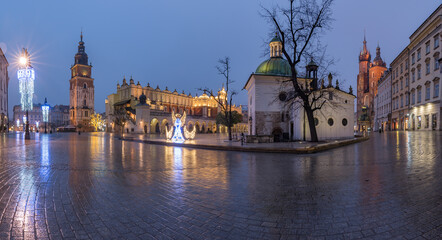 Krakow, Poland, main square panorama with Cloth Hall and St Mary's church on wet December morning