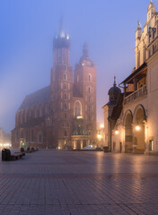 Fototapeta premium Main market square, Cloth Hall and St Mary's church in the misty night, Krakow, Poland