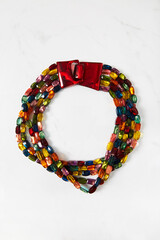 Multicolored multi  strand .red lucite clasp necklace. Made in Mauritius.