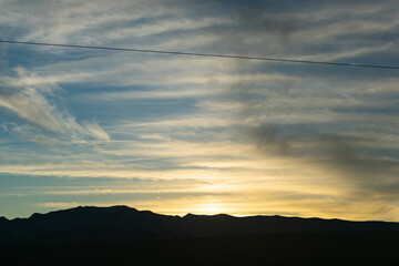 mountain silhouette against a sunset