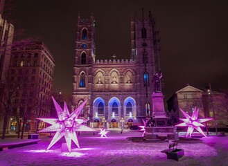 illuminated  winter festive Christmas decoration near Notre Dame Basilica - obrazy, fototapety, plakaty