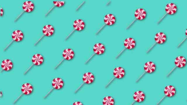 Seamless animation with Christmas Lollipop on light blue background. Xmas traditional festive sweets. 4k footage.