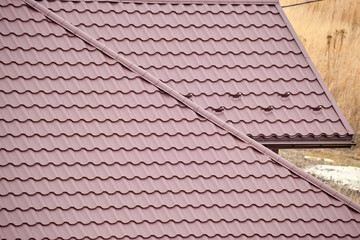 Closeup of house roof top covered with metallic shingles