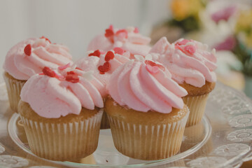 candy color pink cupcakes with red hearts sprinkles on top