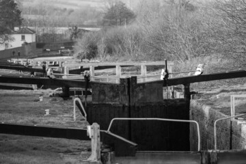 Caen hill Kennet and Avon canal .bridge and lock gate. Monochrome industrial heritage