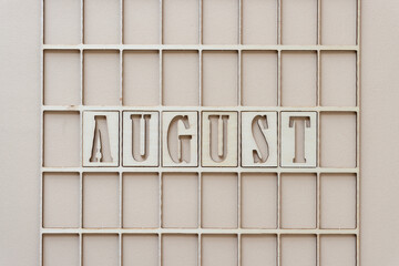 the month "august" in stencil font on paper