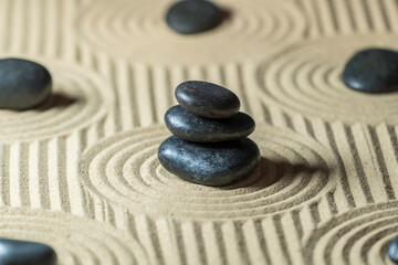 Zen garden with stacked stones on sand. - obrazy, fototapety, plakaty