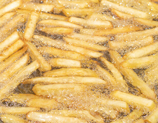 Cooking french fries with oil. Fast food concept.