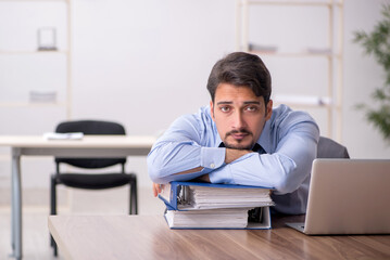 Young male employee working in the office