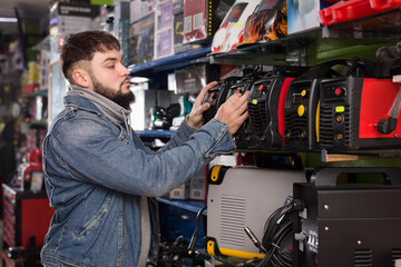 Engineer chooses welding machine in tools store