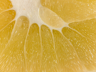a slice of juicy fresh yellow aromatic bergamot very close in detail close-up macro. fruit background. pattern. citrus - obrazy, fototapety, plakaty