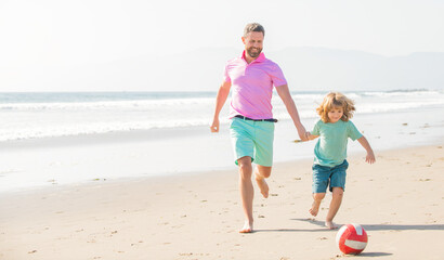 father and son play football on beach. daddy with kid boy on summer day. weekend family day.