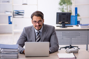 Fototapeta premium Young businessman employee working in the office