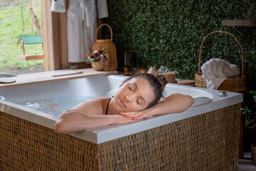 Relaxed Woman resting head in hands in hot tub