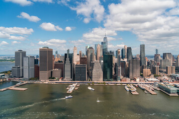 Obraz premium Aerial panoramic city view of Lower Manhattan area over East River, New York City, USA. Bird's eye view from helicopter of metropolis cityscape. A vibrant business neighborhood.