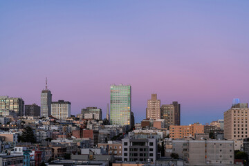 Fototapeta na wymiar Panoramic cityscape view of San Francisco Nob hill area, which is known as a center of San Francisco upper class residential neighborhoods at purple sunset, midtown, California, United States.