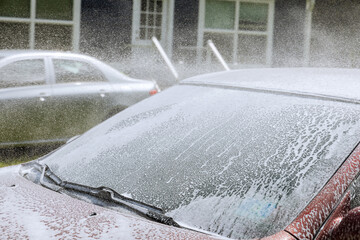 A man spraying pressure washer for car wash in car care