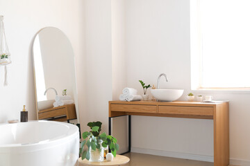 Fototapeta na wymiar Interior of light bathroom with mirror and table