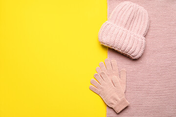Warm hat, gloves and scarf on yellow background