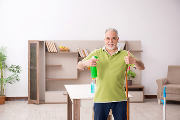 Old man cleaning the house