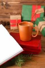 Cup of tasty coffee and books on wooden background