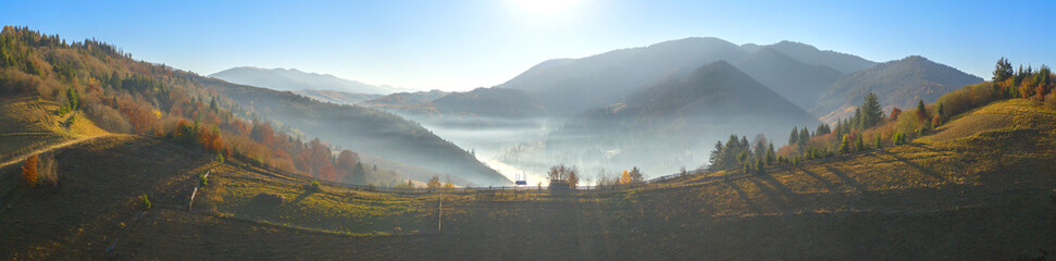 The rays of the sun in the autumn misty forest.