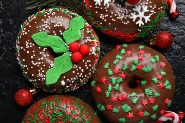 Tasty Christmas donuts on dark background, closeup