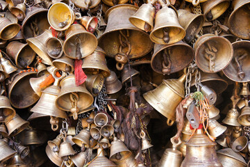 Patan, Nepal: A collection of brass bells hangs outside Ulmant Bhairav Hindu temple in the...