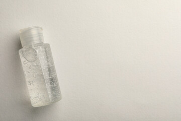 Bottle of cosmetic gel on white background, top view. Space for text