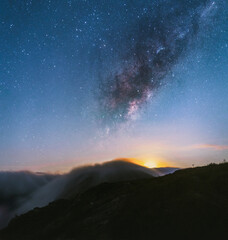 Moonrise behind the mountain with the milky way on the sky
