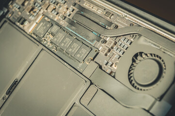 Repair of a modern laptop. Motherboard with close-up cooling system. Disassembled laptop. Selective focus