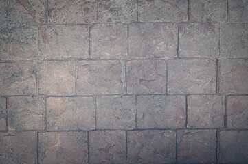 Textured of brick block concrete wall pattern in vintage style and design with vignettes for dark backgrounds.