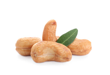 Tasty organic cashew nuts and green leaf isolated on white