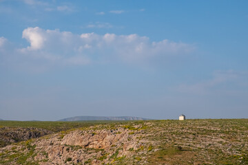 Akmeshit or Akmechet cave. Huge cavern with hole and green trees groving under.